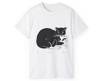 Puede incluir: Camiseta blanca con una ilustración negra de un gato con expresión enfadada. El gato está tumbado y el diseño incluye la firma del artista. La camiseta está hecha de un material suave y cómodo.