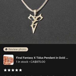 a close-up view of a gold necklace with a pendant featuring a stylized letter 'V' design. The necklace is described as a "Final Fantasy X Tidus Pendant in Gold" and is available for purchase at $395.00. The image also includes a review rating of 4 stars, indicating that the necklace is described as "stunning" and "better than the silver version."