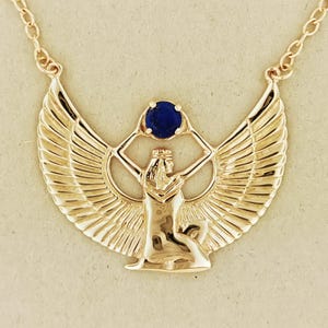 Winged Isis necklace with lapis lazuli in antique bronze Egyptian jewelry. Antique bronze Egyptian goddess necklace featuring lapis lazuli stone