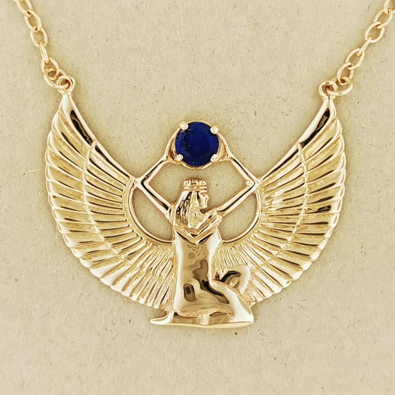Winged Isis necklace with lapis lazuli in antique bronze Egyptian jewelry. Antique bronze Egyptian goddess necklace featuring lapis lazuli stone