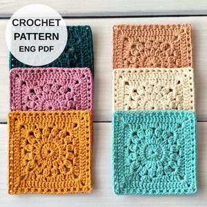 May include: Six square crochet motifs arranged in two columns, featuring a central sunburst design. The colors include dark green, pink, mustard yellow, peach, cream, and teal. Text overlay reads: CROCHET PATTERN ENG PDF.