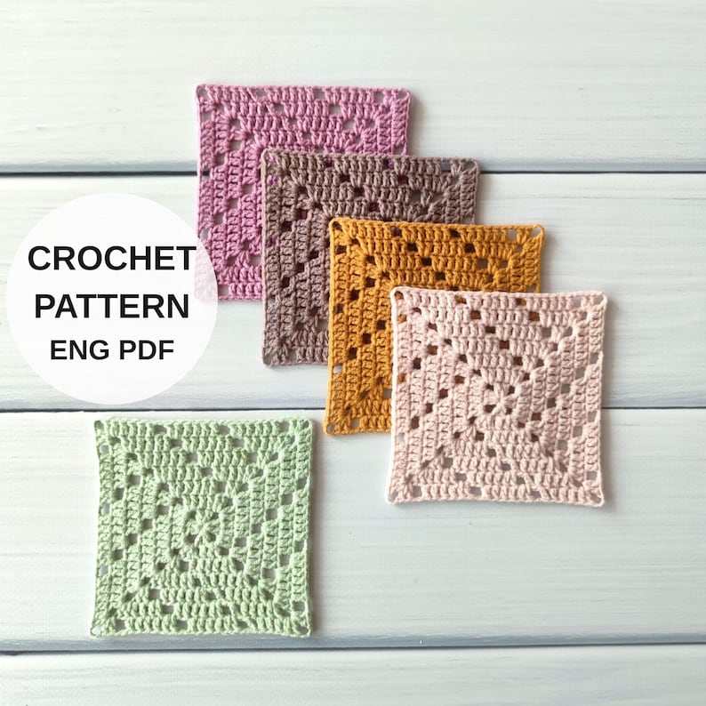 May include: Five square crochet motifs in pink, brown, mustard yellow, light pink, and light green. A white circular overlay features the text CROCHET PATTERN ENG PDF. Each motif displays a classic openwork granny square stitch pattern.