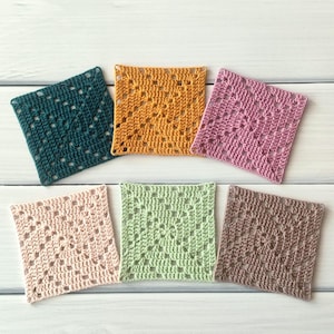 May include: Six square crochet coasters arranged in two rows. The top row features dark teal, mustard yellow, and dusty rose squares. The bottom row includes light blush pink, sage green, and taupe brown squares, all with a classic granny square pattern.