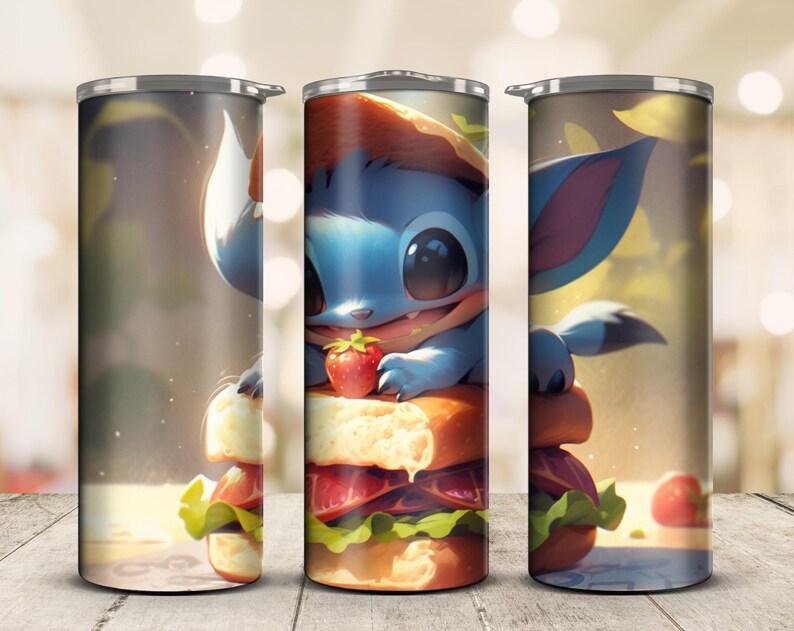 May include: A stainless steel tumbler featuring a cartoon creature with large eyes, perched atop a sandwich with lettuce, tomato, and a strawberry. The design is rendered in soft, pastel colors, creating a whimsical and appealing aesthetic.