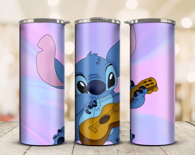May include: A stainless steel tumbler featuring a cartoon illustration of Stitch playing a ukulele. The design is set against a pastel purple and pink gradient background. The tumbler has a silver lid and is designed to hold beverages.