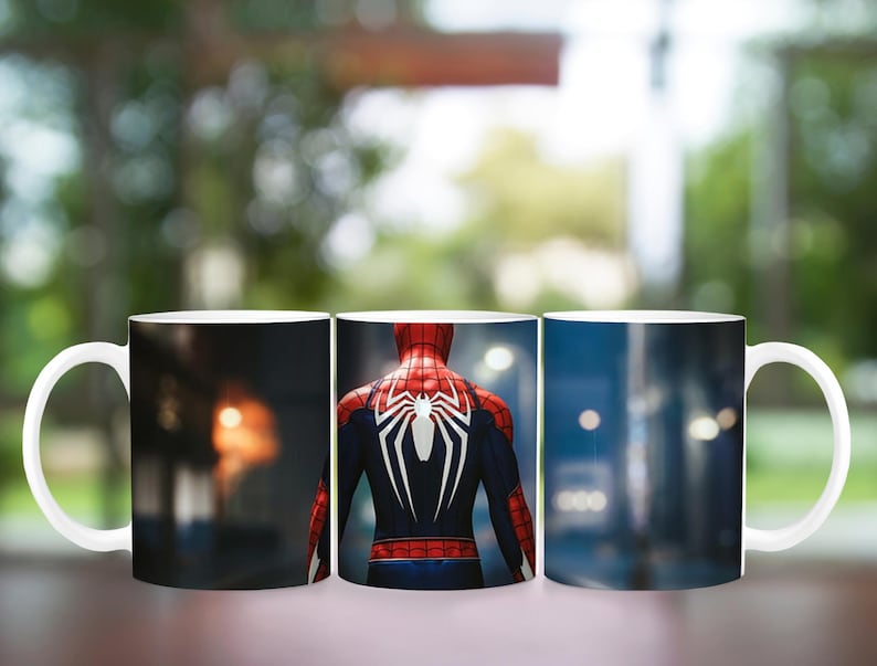 May include: White ceramic mug featuring a design of the Spider-Man character. The design shows the character's back in a red and black suit with a white spider emblem. The background scenes include cityscapes and blurred interiors.