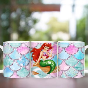 Puede incluir: Taza de cer&aacute;mica blanca con dise&ntilde;o de sirena. La taza presenta una ilustraci&oacute;n de sirena con cabello rojo y cola verde. El fondo tiene un patr&oacute;n de escamas en tonos de azul, rosa y verde azulado.