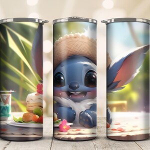 May include: A stainless steel tumbler featuring a blue cartoon character with large eyes and a straw hat. The tumbler has a wraparound design with a picnic scene, including food and flowers. The background is a blurred outdoor setting.