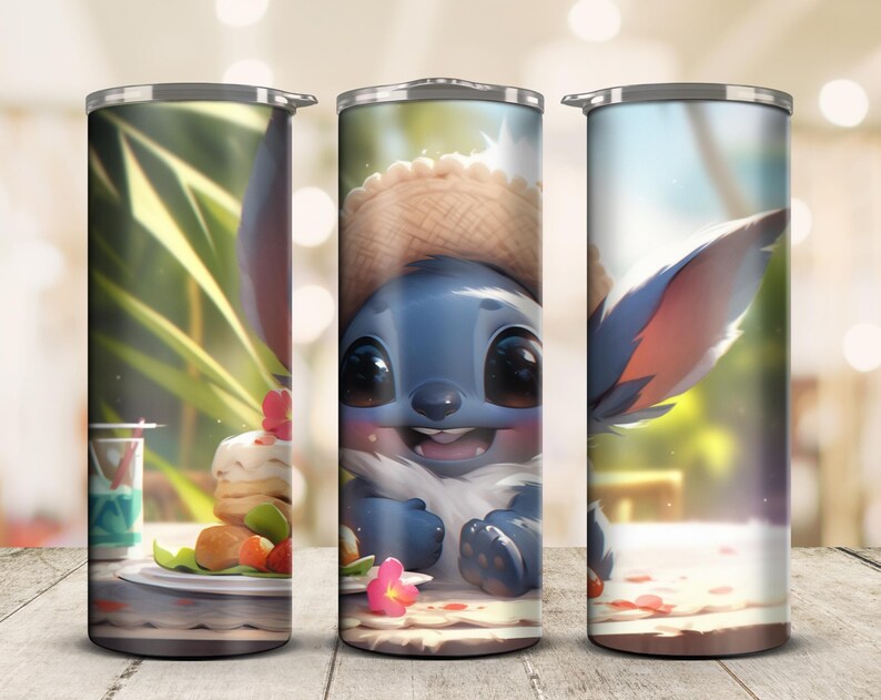 May include: A stainless steel tumbler featuring a blue cartoon character with large eyes and a straw hat. The tumbler has a wraparound design with a picnic scene, including food and flowers. The background is a blurred outdoor setting.