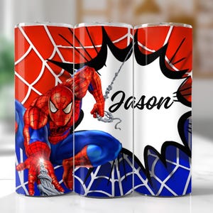 May include: A red, white, and blue tumbler featuring Spider-Man in action. The design includes a spiderweb pattern and a speech bubble with the name "Jason" in black script. The tumbler is cylindrical.