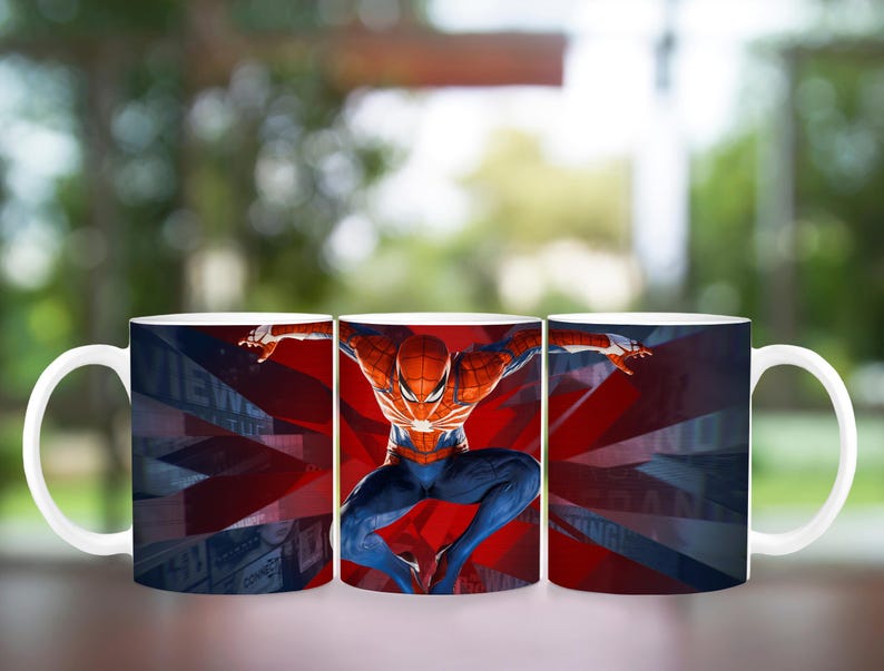 May include: White ceramic mug featuring a vibrant image of Spider-Man in a dynamic pose against a red and blue background. The design includes a stylized Union Jack pattern. The mug has a curved handle.