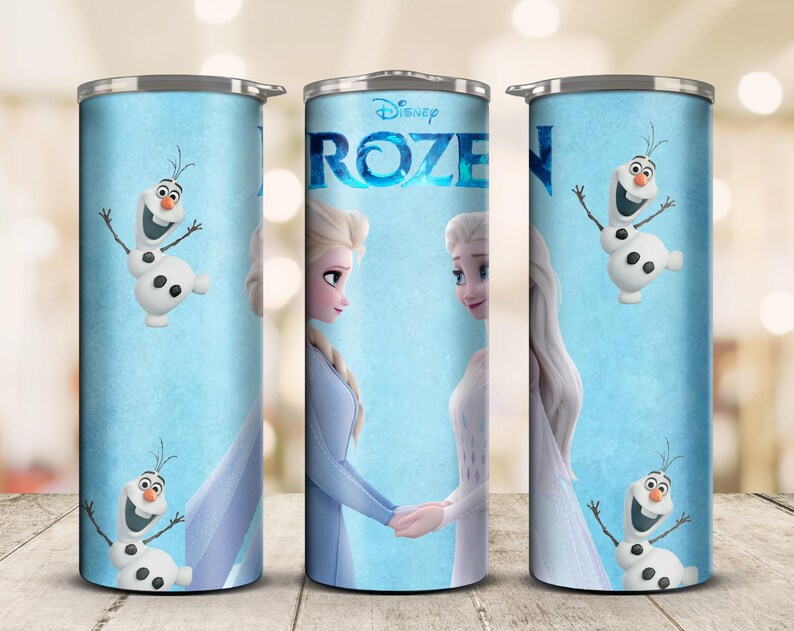 May include: A set of three stainless steel tumblers featuring characters from Disney's Frozen. The tumblers have a light blue background with images of Elsa, Anna, and Olaf. The word "Frozen" is displayed in a blue, stylized font.