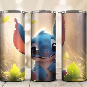 May include: A stainless steel tumbler featuring a cartoon character with blue fur, large black eyes, and large ears. The design includes a light background with yellow and green foliage. The tumbler is cylindrical and has a silver lid.