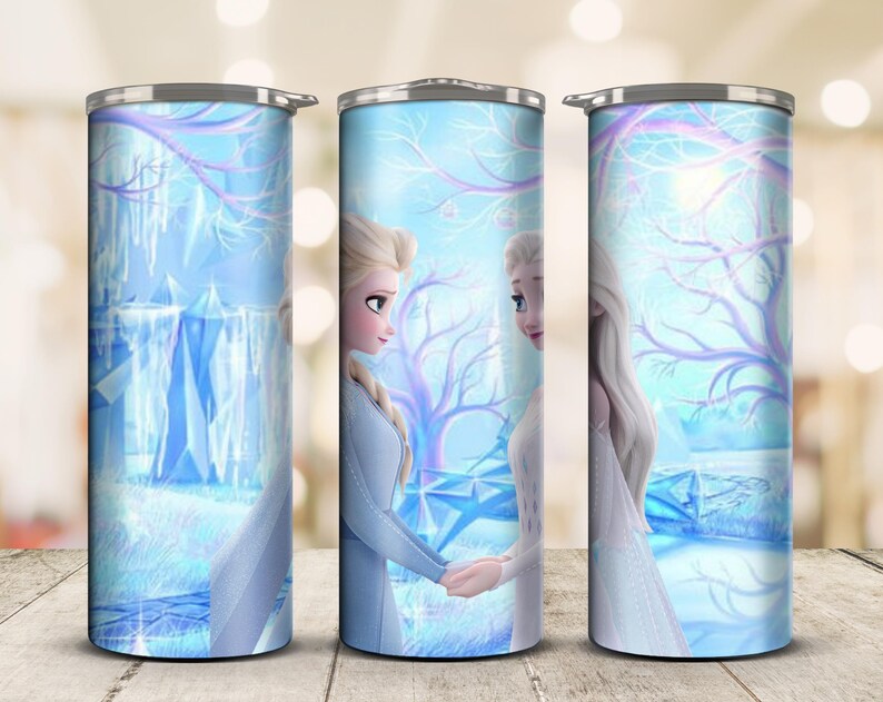 May include: A stainless steel tumbler featuring a winter scene with two animated female characters in light blue dresses, holding hands. The design includes a snowy landscape with trees and ice formations, all in shades of blue and white.
