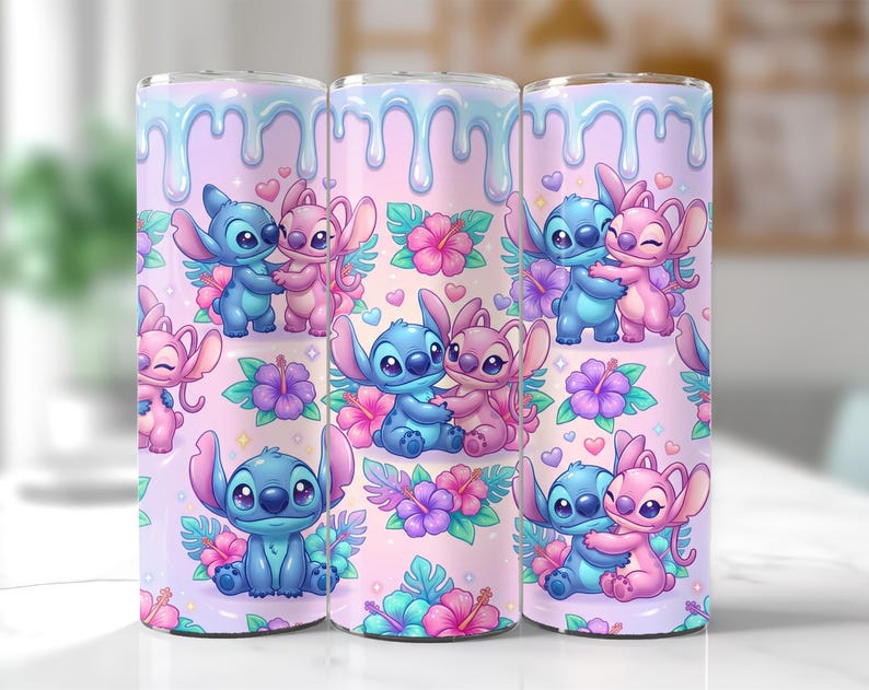 May include: Three stainless steel tumblers with a repeating pattern of blue and pink cartoon characters, flowers, and hearts. The background is a light pink with a blue dripping design at the top. The tumblers are decorated with a cute, colorful design.