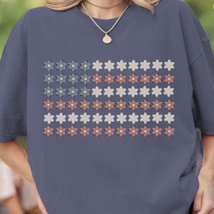 May include: A set of three ceramic mugs with a speckled, matte finish. The mugs are in shades of cream, light gray, and dark gray. Each mug has a simple, minimalist design and a rounded handle. Perfect for coffee or tea.