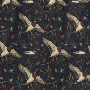 May include: Dark blue fabric with a repeating pattern of ducks in flight and on the water. The ducks have green heads, brown chests, and white and brown wings. The design includes cattails, leaves, and the text "Hunt & Harbor" and "H&H".