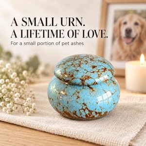 May include: A small, round ceramic urn featuring a bright turquoise glaze with a dark brown crackle pattern. The text A SMALL URN. A LIFETIME OF LOVE. For a small portion of pet ashes is visible above the urn, which has a matching lid.