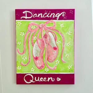 May include: A pink and green canvas painting with the words "Dancing Queen" and a pair of pink ballet shoes with pink bows.