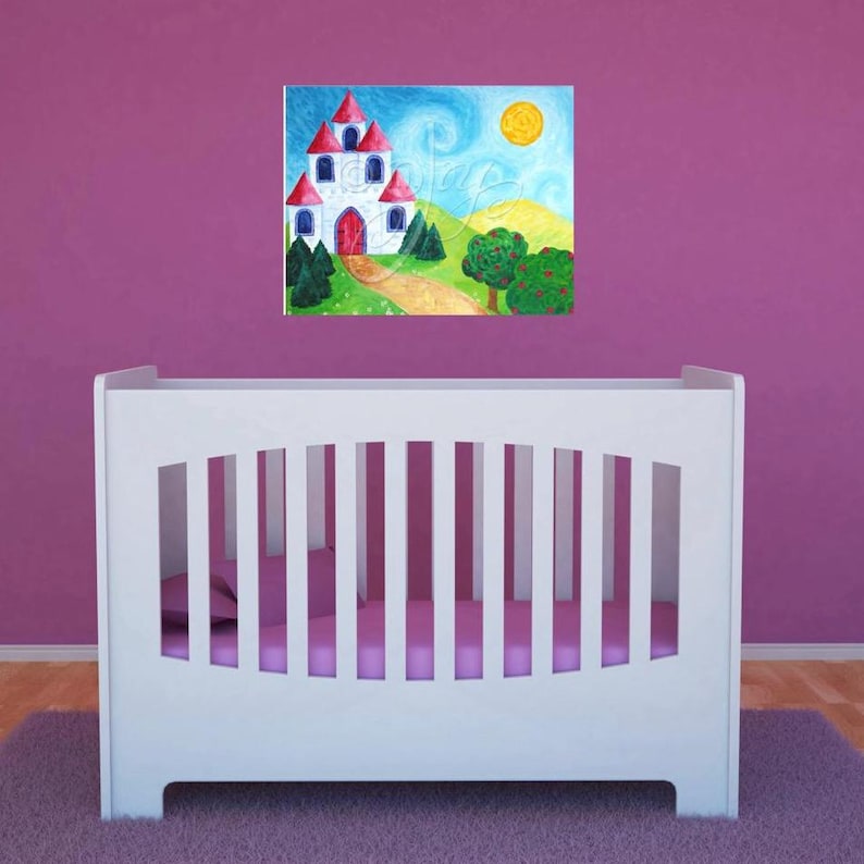 May include: A white crib with a pink mattress and a painting of a white castle with red roofs and a yellow sun above it on a pink wall.