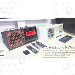 May include: Black and white ArenaSound NVMe Hub with orange honeycomb speaker grill and red accents. Includes USB drives, SD card, and a smartphone. The text on the device reads "ArenaSound NVMe Hub".