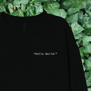May include: Black sweatshirt with the text "Hello World!" printed in white on the front.