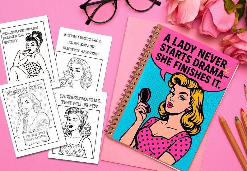 May include: A spiral-bound notebook with a pop art illustration of a woman holding a compact mirror, with the text "A LADY NEVER STARTS DRAMA - SHE FINISHES IT." Also, there are several black and white retro-style cards.