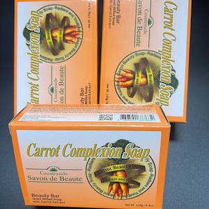 May include: Three orange boxes of Carrot Complexion Soap, a beauty bar with carrot extract. Each box features a green and white logo with the text "Carrot Complexion Soap" and "Countryside Savon de Beaute". The front of each box also features a circular image of a carrot with the text "Carrot Beauty Soap - Radiant and Youthful".