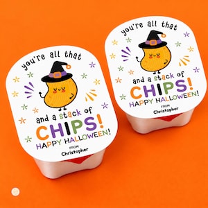 May include: Two white snack containers with square labels featuring a cartoon potato wearing a witch hat. The text reads: you're all that and a stack of CHIPS! HAPPY HALLOWEEN! FROM Christopher. The labels include colorful star accents.