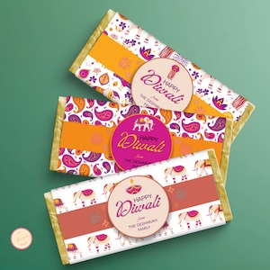 May include: Three chocolate bars with Diwali-themed packaging. The bars have colourful designs with paisley patterns, elephants, and the words "Happy Diwali" on a circular label. The packaging includes gold foil accents.