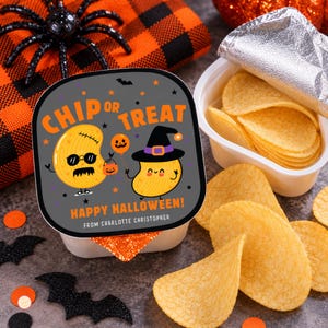 May include: A white plastic snack container with a square lid featuring the text CHIP OR TREAT HAPPY HALLOWEEN FROM CHARLOTTE CHRISTOPHER, illustrated with two cartoon potato chips, one wearing sunglasses and one wearing a witch hat, filled with potato chips.