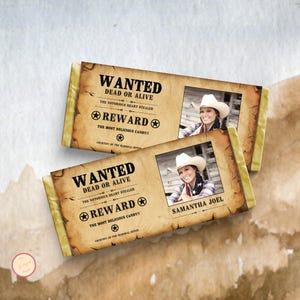 May include: Two candy bar wrappers with a vintage "Wanted" poster design. The design includes the text "Wanted Dead or Alive", "Reward", and a photo of a woman in a cowboy hat. The text "The Most Delicious Candy!!" is also included.