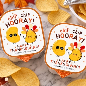May include: Two square white snack containers with orange borders, each featuring a cartoon potato chip wearing sunglasses and a cartoon turkey chip. The text reads chip, chip HOORAY! HAPPY THANKSGIVING! FROM CHARLOTTE CHRISTOPHER in orange and brown.