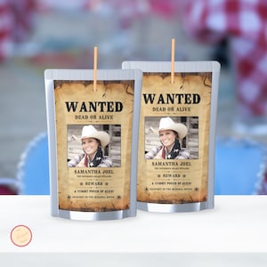 May include: Two silver pouches with a "Wanted" poster design. Each pouch features a photo of a woman in a cowboy hat, with text that reads "Wanted Dead or Alive" and "Samantha Joel". The pouches have a straw.