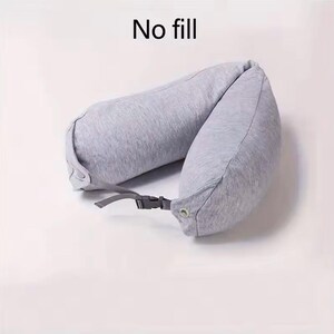 May include: A gray travel neck pillow with a buckle closure. The pillow is U-shaped and made of a soft fabric. The text "No fill" is printed at the top of the image.
