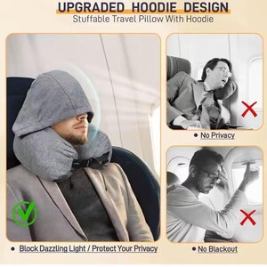 May include: A gray travel pillow with an attached hood, designed for comfort and privacy. The pillow is around the neck, and the hood is up. The text on the image says "UPGRADED HOODIE DESIGN" and "Stuffable Travel Pillow With Hoodie."