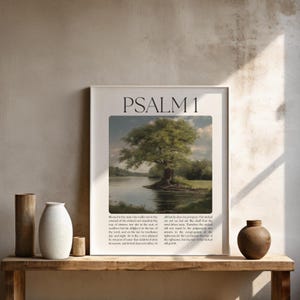 May include: Framed art print featuring a landscape painting of a large tree by a lake. The print has the text "PSALM 1" at the top. The artwork is displayed on a wooden shelf with decorative vases and a small jar.