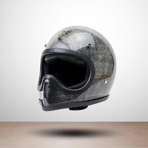 May include: A black and gray motorcycle helmet with a textured pattern. The helmet has a black interior and trim, with a small logo on the top. The helmet is designed for safety and style.