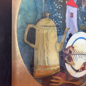 Macro view of the ornate golden teapot in the collage, highlighting its intricate etched detailing and golden tones. The background features dark teal and textured blue patterns, evoking lace or embroidery. Edges of the circular artwork are also visible against a metallic gold background.