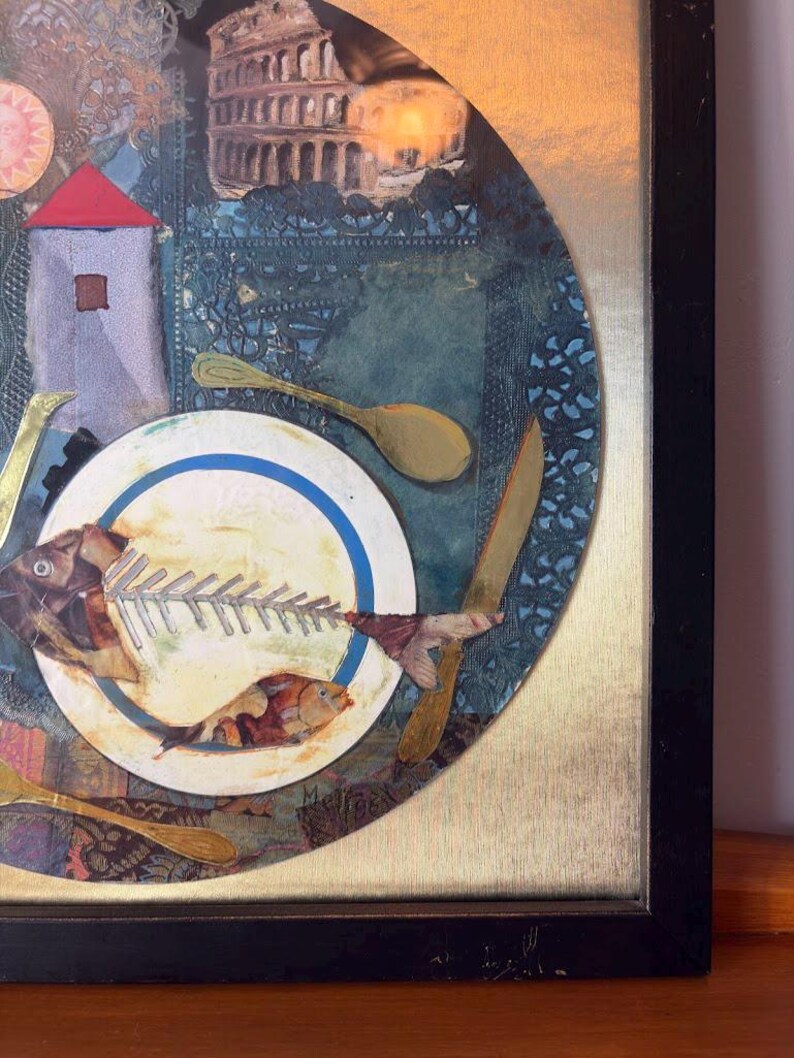 Close-up of the bottom right corner focusing on the fishbone plate and the artist’s signature, “Meli 96,” at the edge. The composition includes a knife and spoon on either side, collaged fabric textures, and muted gold leaf details on a canvas-like background.