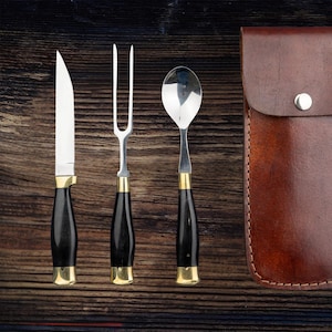 Medieval horn cutlery set with brown leather case that attaches to belt.