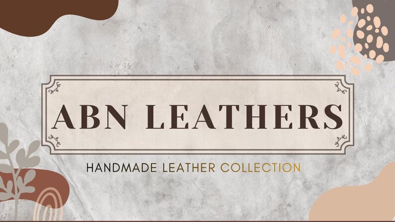 May include: A promotional graphic for ABN Leathers, featuring a rectangular frame with the brand name in dark brown letters. Below, the text reads "HANDMADE LEATHER COLLECTION" in a gold color. The background has a textured, light gray appearance with brown and peach-colored abstract shapes.