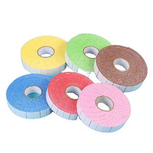 May include: Six circular rolls of double-sided foam adhesive tape in yellow, light green, brown, blue, red, and pink. Each roll features a central white cardboard core and a textured foam surface designed for mounting and craft projects.