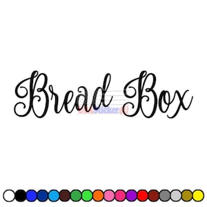 May include: Black cursive text on a white background reads "Bread Box." The text is in a decorative, flowing font. A color palette of various colors is displayed at the bottom of the image.