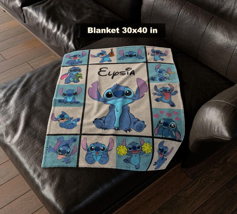 May include: A blue and white blanket featuring the character Stitch from Lilo & Stitch. The blanket is 30 x 40 inches and has a grid pattern with various images of Stitch. The name "Eupsia" is written on the blanket.