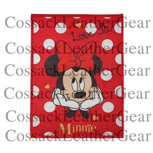 May include: Red blanket with white polka dots and a Minnie Mouse graphic. The blanket features Minnie's face, a red bow, and the words "Love ya" and "Minnie".