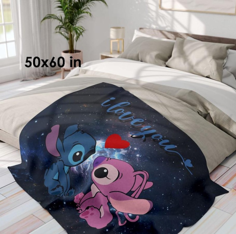 May include: A dark blue throw blanket with a space-themed design featuring two cartoon characters, a red heart, and the words "i love you." The blanket measures 50 x 60 inches.