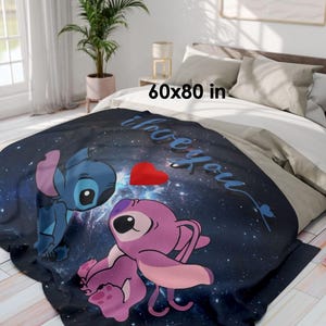 May include: A navy blue fleece blanket featuring cartoon characters Stitch and Angel, with a red heart and the words "I love you." The blanket measures 60 x 80 inches.