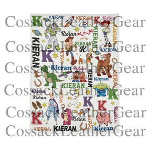 May include: A white blanket featuring various Toy Story characters, including Buzz Lightyear, Woody, and others. The blanket has the name "Kieran" printed throughout, along with the letter "K" and other decorative elements. The blanket is rectangular.