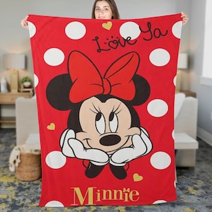 May include: Red blanket featuring Minnie Mouse with a large red bow, white polka dots, and the words "Love Ya" and "Minnie" in gold. The blanket has a cartoon design with gold heart accents.